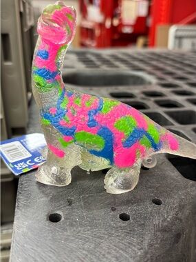 Clear Resin Dinosaur Toy with Neon Pink, Blue & Green Splotches